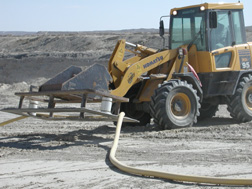 Tractor with a cable attachment is used to move dragline cable when positioning the dragline.