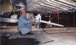 Heavy pneumatic wrench is attached to a counterbalance weight and suported by an overhead crane when changing the cutting edges on a blade.