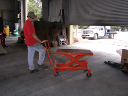 Scissors-lift table is used to position and work on parts when repairing equipment.